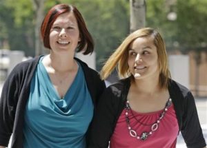 Angie, right, and Kami Roe of West Jordan arrive at the federal courthouse Wednesday, July 15, 2015, in Salt Lake City. A federal judge has ordered the state of Utah to list the names of the lesbian couple on a birth certificate as the mothers of their new baby. U.S. District Judge Dee Benson said the case wasn't hard to decide in the wake of the U.S. Supreme Court ruling legalizing same-sex marriage. (AP Photo/Rick Bowmer)