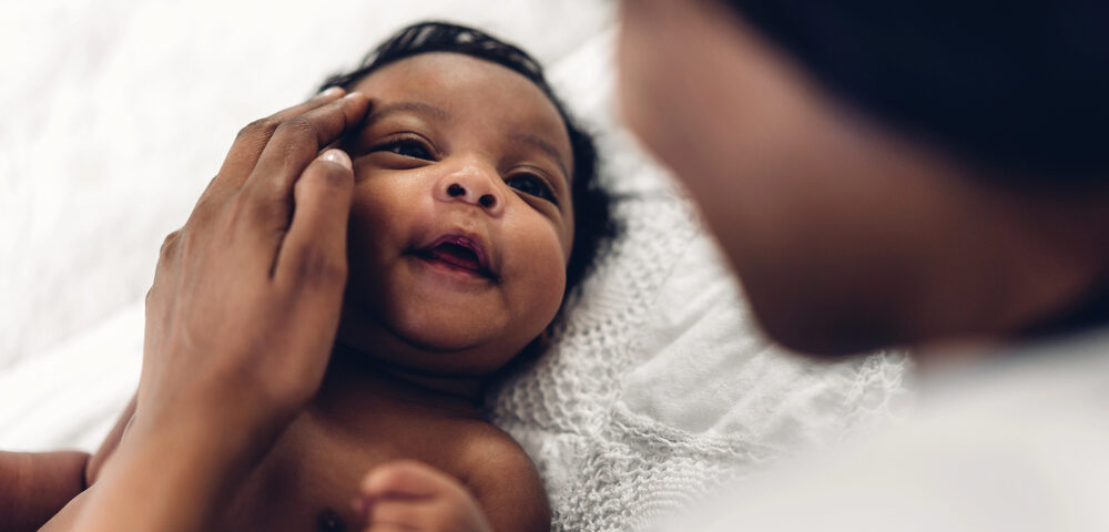 Baby born through IVF looking at mom