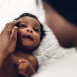 Baby born through IVF looking at mom
