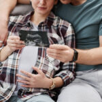 California couple expecting baby looking at sonogram
