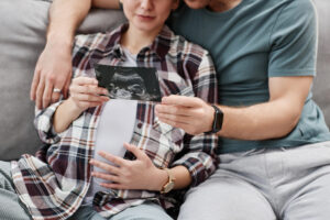 California couple expecting baby looking at sonogram